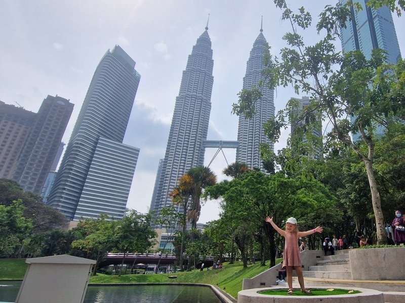 Kind vor den Petronas Towers in Kuala Lumpur
