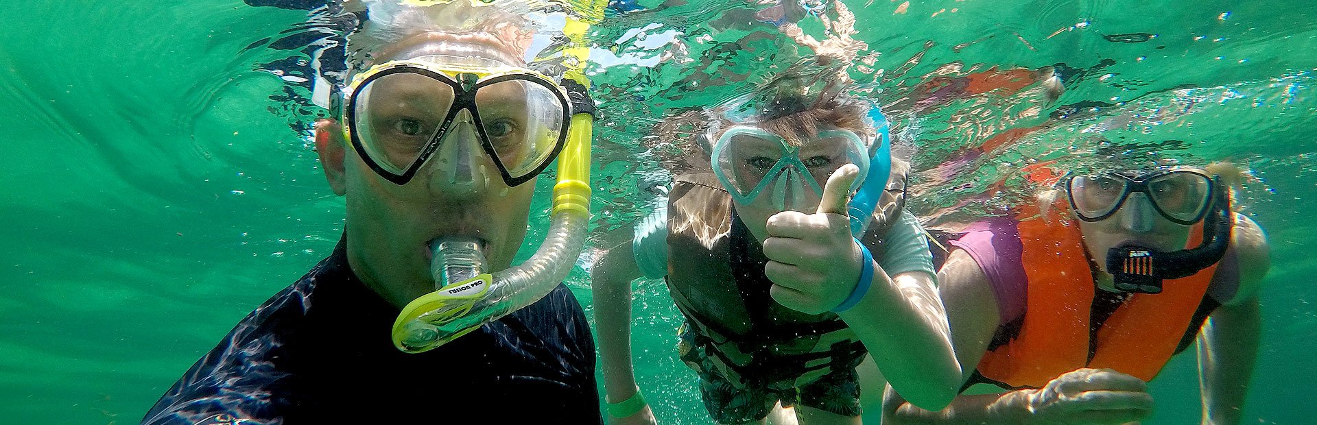 Familie schnorchelt im Meer